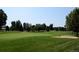 Lush green golf course with sand traps and trees, offering scenic views at 13901 E Marina Dr # 109, Aurora, CO 80014