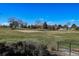 Scenic view of a lush green golf course with sand traps and trees at 13901 E Marina Dr # 109, Aurora, CO 80014