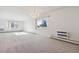 Living room with plush carpet, large windows, a chandelier, and wall-mounted AC unit at 13901 E Marina Dr # 109, Aurora, CO 80014