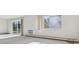 Living room with carpet, sliding glass door to a balcony, and a large window at 13901 E Marina Dr # 109, Aurora, CO 80014