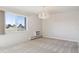 Living room with carpet flooring, a chandelier, large window, and wall-mounted AC unit at 13901 E Marina Dr # 109, Aurora, CO 80014