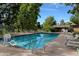 Community pool with lounge chairs, a pool lift, and a nearby clubhouse at 13901 E Marina Dr # 109, Aurora, CO 80014