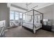 Bright bedroom with a four-poster bed and city view at 7600 Landmark Way # 1107, Greenwood Village, CO 80111