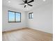 Bright bedroom with large window and ceiling fan at 7340 Van Sickle St, Strasburg, CO 80136