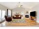 Living room with hardwood floors, fireplace, and access to deck at 35100 E 120Th Ave, Hudson, CO 80642