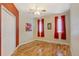Simple bedroom with hardwood floors and red accent wall at 35100 E 120Th Ave, Hudson, CO 80642