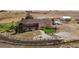 Aerial view of a two-story house with a large yard and outbuildings at 35100 E 120Th Ave, Hudson, CO 80642