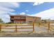 Two-story house exterior with a gravel driveway and wooden fence at 35100 E 120Th Ave, Hudson, CO 80642