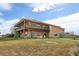 Two-story house exterior with a large deck and hot tub at 35100 E 120Th Ave, Hudson, CO 80642