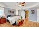 Bright main bedroom with wood floors and sliding barn door at 35100 E 120Th Ave, Hudson, CO 80642