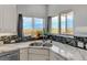Kitchen corner sink with views and white cabinetry at 35100 E 120Th Ave, Hudson, CO 80642