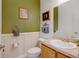 Powder room with wood vanity and green walls at 35100 E 120Th Ave, Hudson, CO 80642