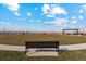 Black metal bench overlooking a community park with a pergola at 2224 Alyssa St, Fort Lupton, CO 80621