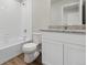Clean bathroom, granite countertop, white cabinets, and bathtub at 2224 Alyssa St, Fort Lupton, CO 80621