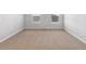 Well-lit bedroom includes neutral carpeting and two windows at 2224 Alyssa St, Fort Lupton, CO 80621