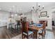 Bright dining room with a rustic wood table and chandelier, adjacent to the kitchen at 3093 Belay Pt, Castle Rock, CO 80108