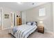 Simple bedroom with a striped bedspread and nightstand at 3093 Belay Pt, Castle Rock, CO 80108