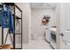 Bright laundry room with washer and dryer and shelving at 3093 Belay Pt, Castle Rock, CO 80108