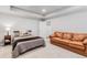 Basement bedroom with a queen bed and a couch at 3093 Belay Pt, Castle Rock, CO 80108