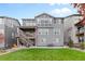 Gray house with a deck, patio, and firepit, plus a grassy backyard at 3093 Belay Pt, Castle Rock, CO 80108