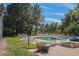 Community pool with lounge chairs and surrounding landscaping at 2525 S Dayton Way # 1109, Denver, CO 80231