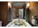 Stylish powder room with a unique sink and mosaic tile at 17575 E Kettle Pl, Centennial, CO 80016