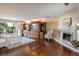 Luxurious main bedroom with fireplace, large windows, and hardwood floors at 17575 E Kettle Pl, Centennial, CO 80016