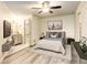 Main bedroom with ensuite bathroom and ceiling fan at 1820 Newland Ct # 213, Lakewood, CO 80214