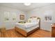 Bright bedroom with hardwood floors and a wicker bed frame at 1529 Holly, Denver, CO 80220