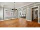 Spacious dining room with hardwood floors and chandelier, open to kitchen at 1529 Holly, Denver, CO 80220