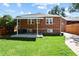 Brick home with covered patio, and fenced backyard at 1529 Holly, Denver, CO 80220