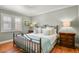Main bedroom with hardwood floors and a neutral color palette at 1529 Holly, Denver, CO 80220