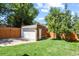 Detached brick garage with driveway and grassy area at 1529 Holly, Denver, CO 80220