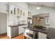 Modern kitchen with white cabinets, stainless steel appliances and an island at 1529 Holly, Denver, CO 80220