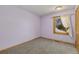 Simple bedroom with light purple walls and carpeted floor at 1233 Twin Peaks Cir, Longmont, CO 80503