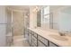 Main bathroom with double vanity, shower, and tiled floors at 2030 Wagon Wheel Aly, Brighton, CO 80601