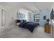Virtually staged bedroom with a blue accent wall and comfortable bed at 1265 Race St # 208, Denver, CO 80206