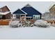 Winter backyard view of a charming home with a snow covered yard at 6242 N Genoa St, Aurora, CO 80019