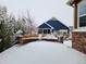 View of a backyard with snow, brick wall and neighboring house at 6242 N Genoa St, Aurora, CO 80019