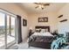 Bright bedroom with a queen-size bed and sliding door to patio at 12346 Shiloh Point Dr, Littleton, CO 80127