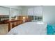 Bedroom with mirrored closet doors and a wooden bed frame at 16941 E Chenango Ave # C, Aurora, CO 80015