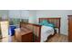 Bright bedroom with wood flooring and a wooden bed frame at 16941 E Chenango Ave # C, Aurora, CO 80015
