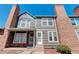 Brick and gray siding townhouse exterior with landscaping at 16941 E Chenango Ave # C, Aurora, CO 80015