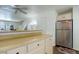 Stainless steel refrigerator in kitchen with light cabinets at 16941 E Chenango Ave # C, Aurora, CO 80015