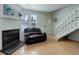 Living room with hardwood floors, fireplace, and access to the front entrance at 16941 E Chenango Ave # C, Aurora, CO 80015