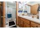 Clean bathroom with a shower/tub combo and wooden vanity at 2617 E Egbert St, Brighton, CO 80601
