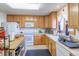Bright kitchen featuring wood cabinets, an island, and modern appliances at 2617 E Egbert St, Brighton, CO 80601