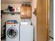 Laundry room with washer, dryer, and storage shelves at 2617 E Egbert St, Brighton, CO 80601