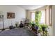 Bright living room with bay window, lots of plants, and a cozy sitting area at 2617 E Egbert St, Brighton, CO 80601