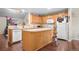 Open kitchen with island and views into the dining area at 6139 Shamrock Cir, Frederick, CO 80530